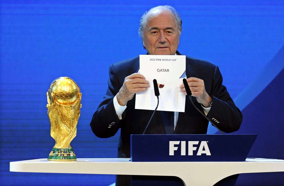 Sepp Blatter, damals Fifa-Präsident, hält am 2. Dezember 2010 einen Zettel mit der Aufschrift „Qatar“ während der Bekanntgabe des Ausrichters der Fußball-WM 2022 hoch. Foto: Walter Bieri/KEYSTONE/dpa/Walter Bieri