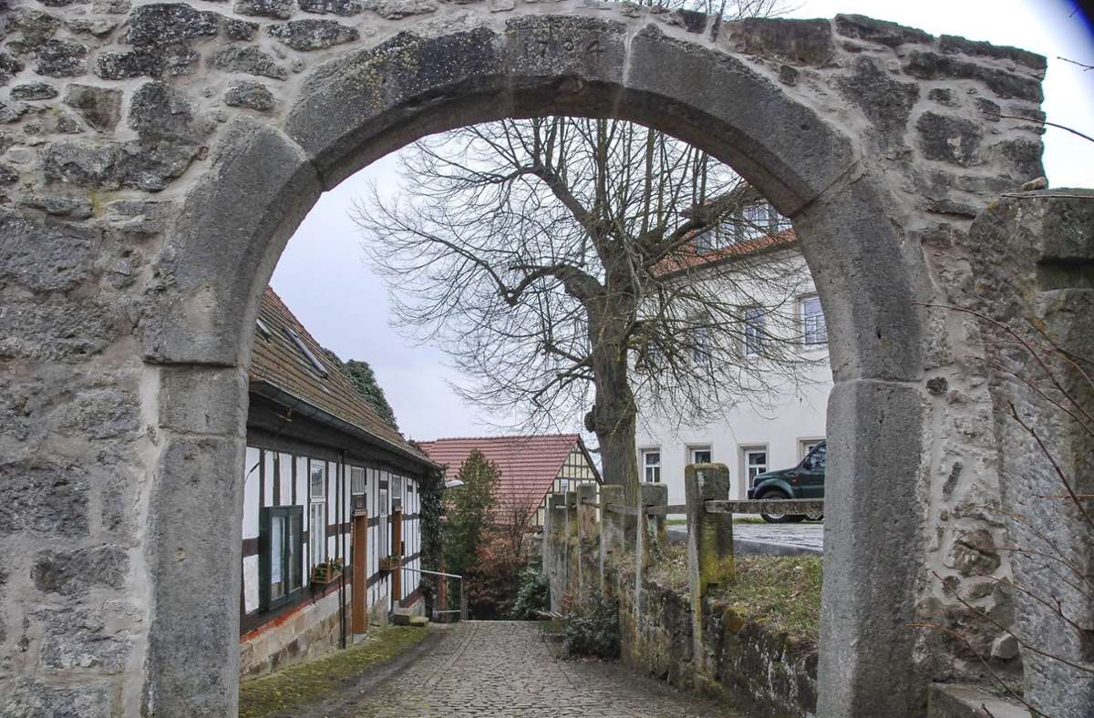 Ein Blick durch den historischen Torbogen – links das Gemeindehaus, rechts das Schweickershäuser Schloss. Foto: Kurt Lautensack